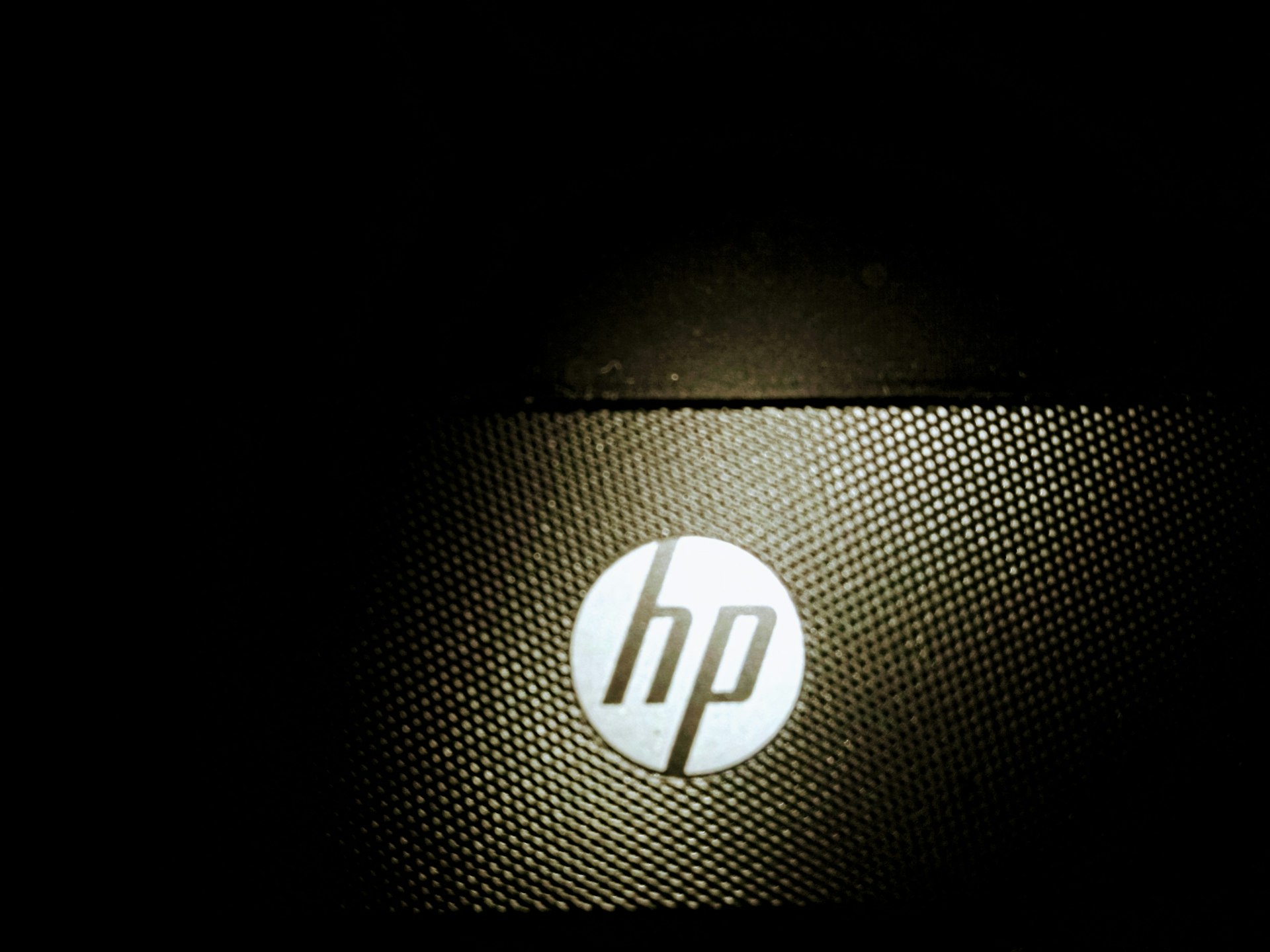 a close up of a hp logo on a laptop